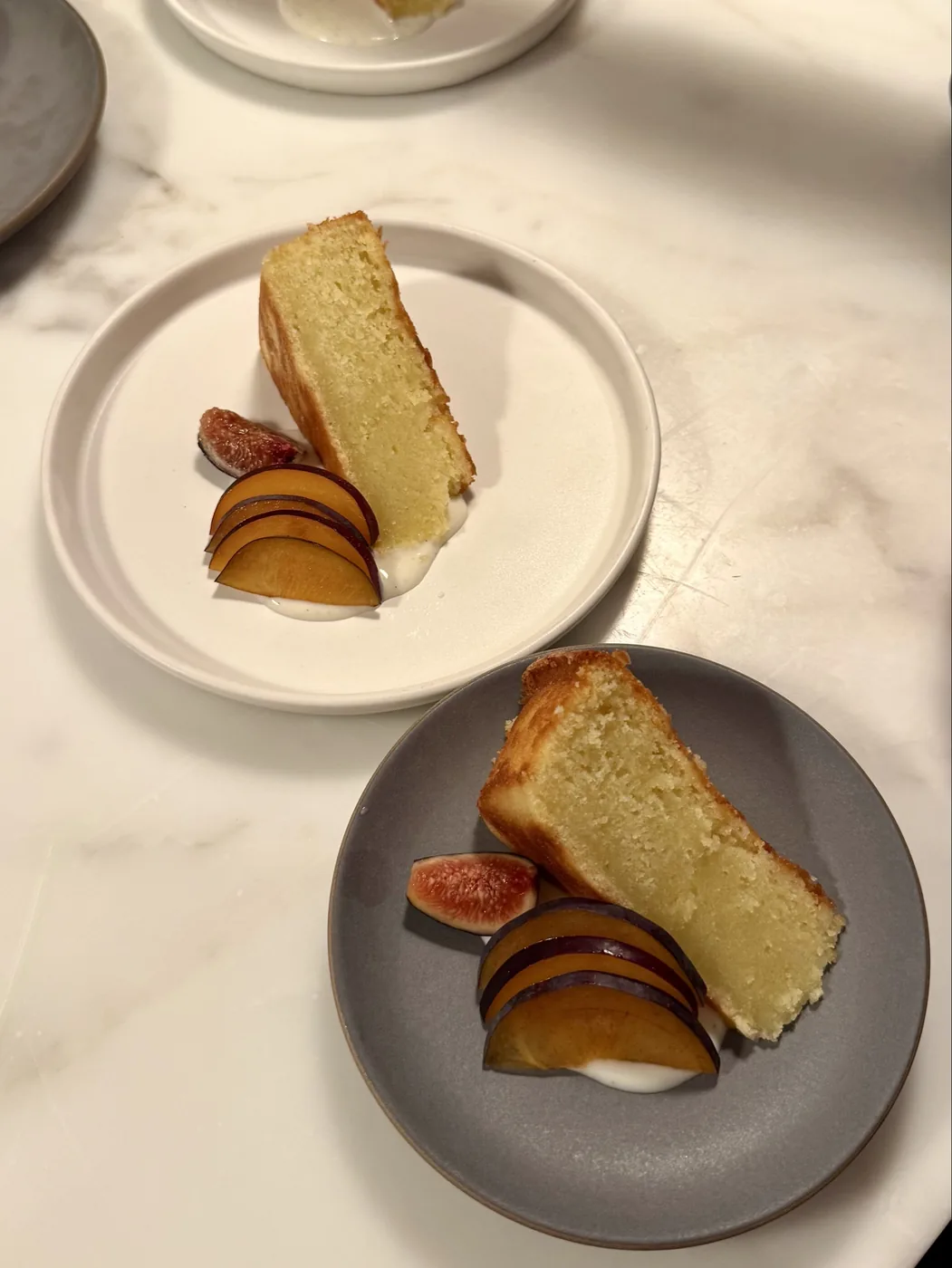 Slices of olive oil cake served with stone fruit and yogurt