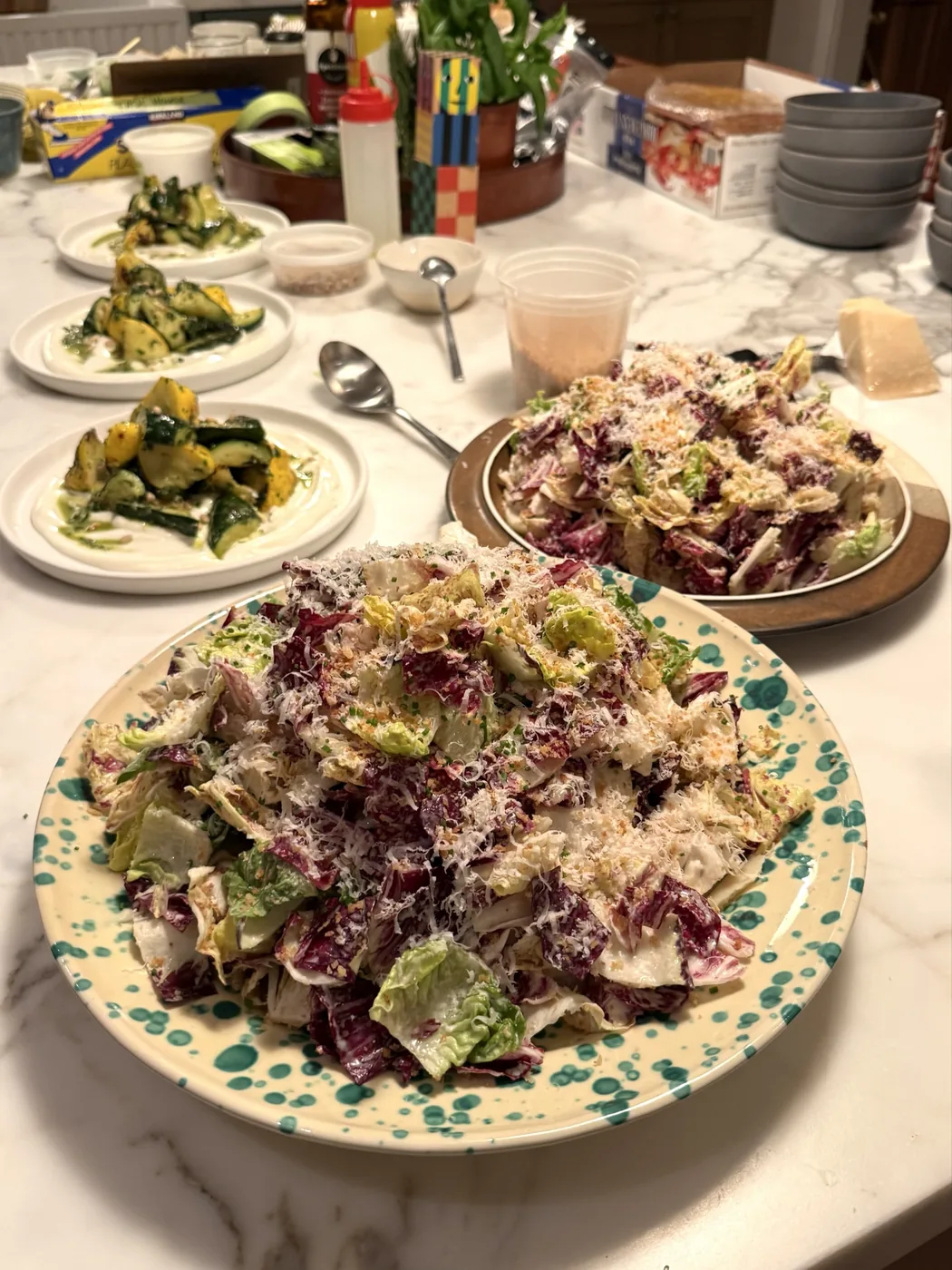 Radicchio Caesar salad with plates of pesto grilled zucchini